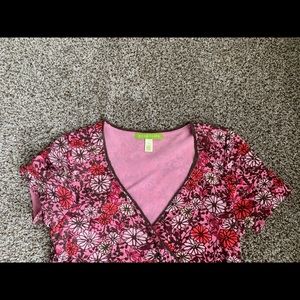 Wrap style blouse with raw edge (but stitched) bottom. Lots of detail.